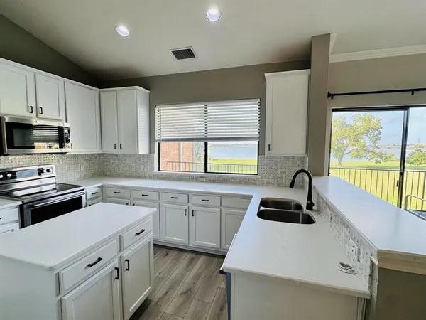 a kitchen that has a sink and a stove in it