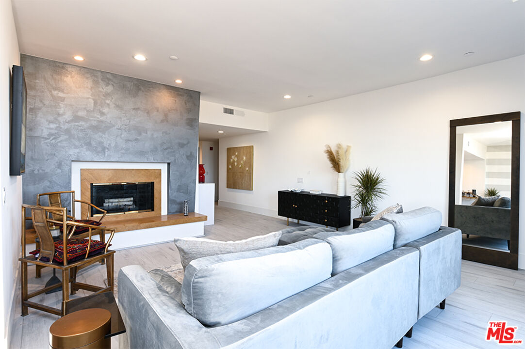235 South Reeves Drive, Unit 301 Beverly Hills, CA 90212 - Photo 1 of 18 a living room with furniture and a fireplace