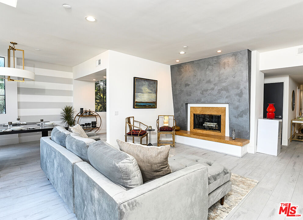 235 South Reeves Drive, Unit 301 Beverly Hills, CA 90212 - Photo 2 of 18 a living room with furniture and a fireplace