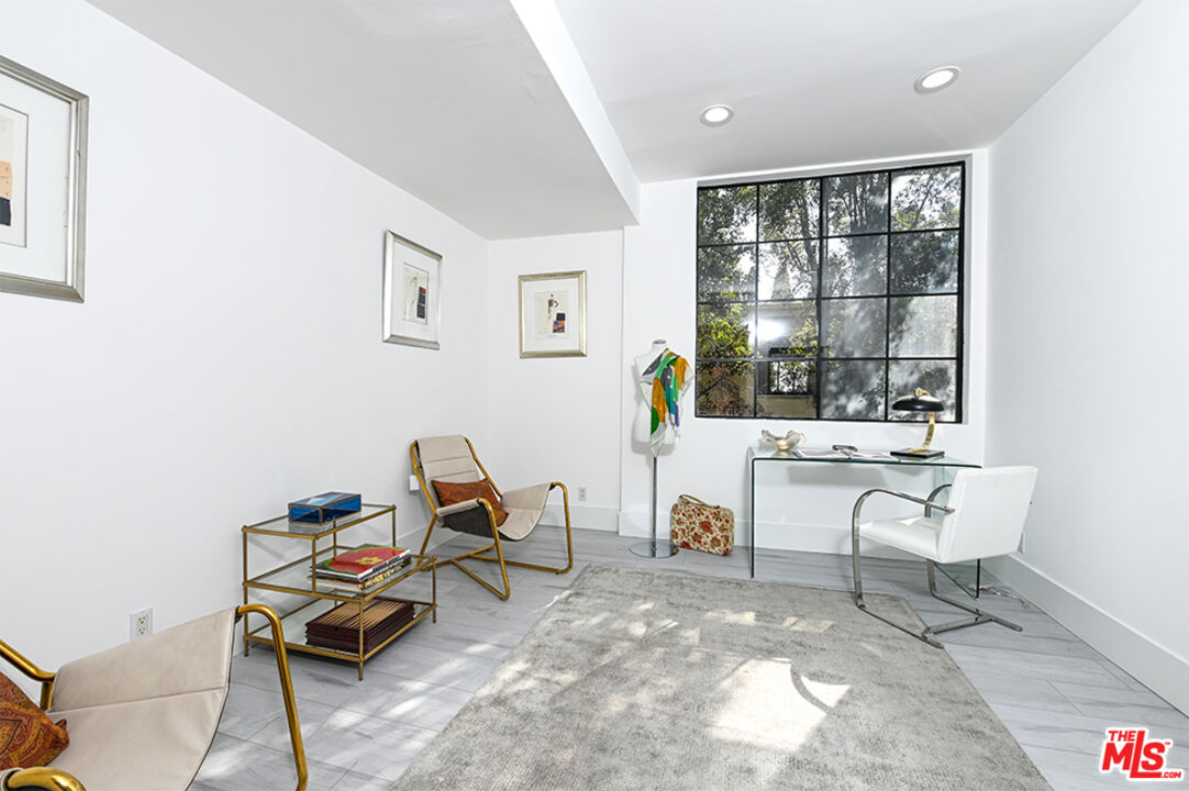 235 South Reeves Drive, Unit 301 Beverly Hills, CA 90212 - Photo 12 of 18 a living room with furniture and a window