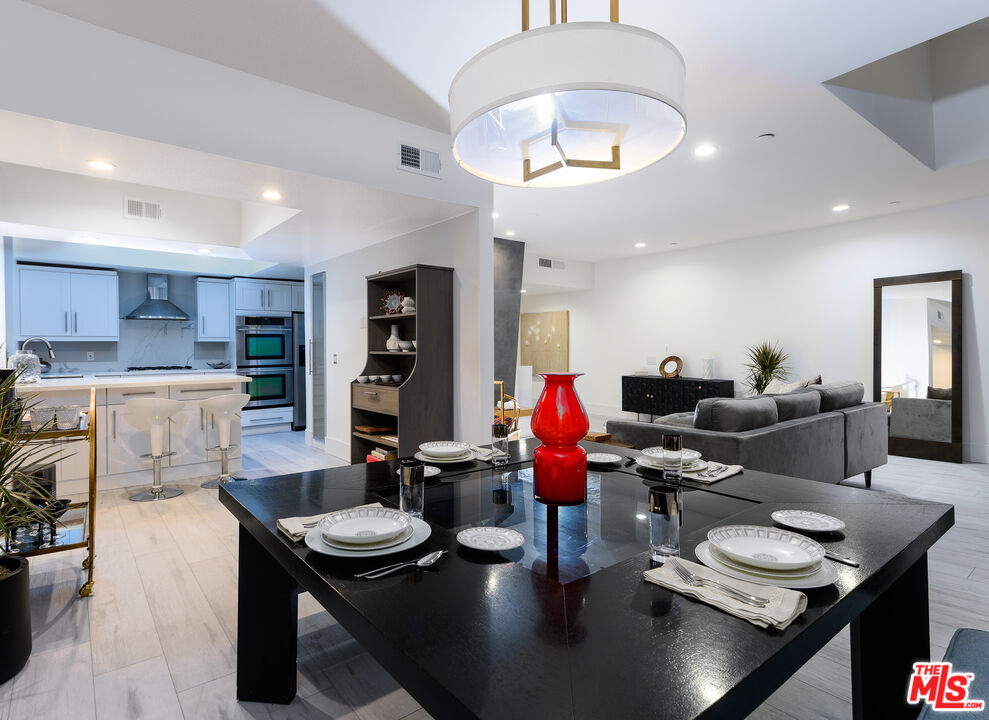 235 South Reeves Drive, Unit 301 Beverly Hills, CA 90212 - Photo 4 of 18 a room with furniture and a view of kitchen