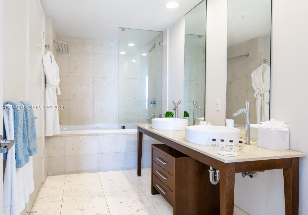 485 Brickell Avenue, Unit 4307 Miami, FL 33131 - Photo 13 of 21 a bathroom with a sink double vanity mirror and a bathtub
