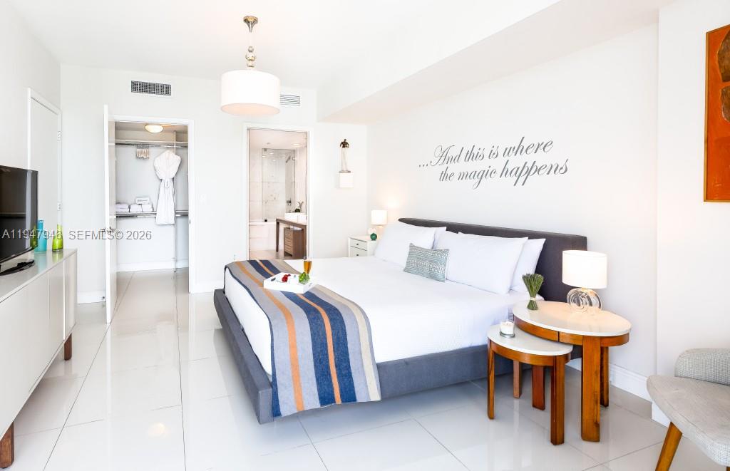 485 Brickell Avenue, Unit 4307 Miami, FL 33131 - Photo 15 of 21 a spacious bedroom with a bed and a flat screen tv