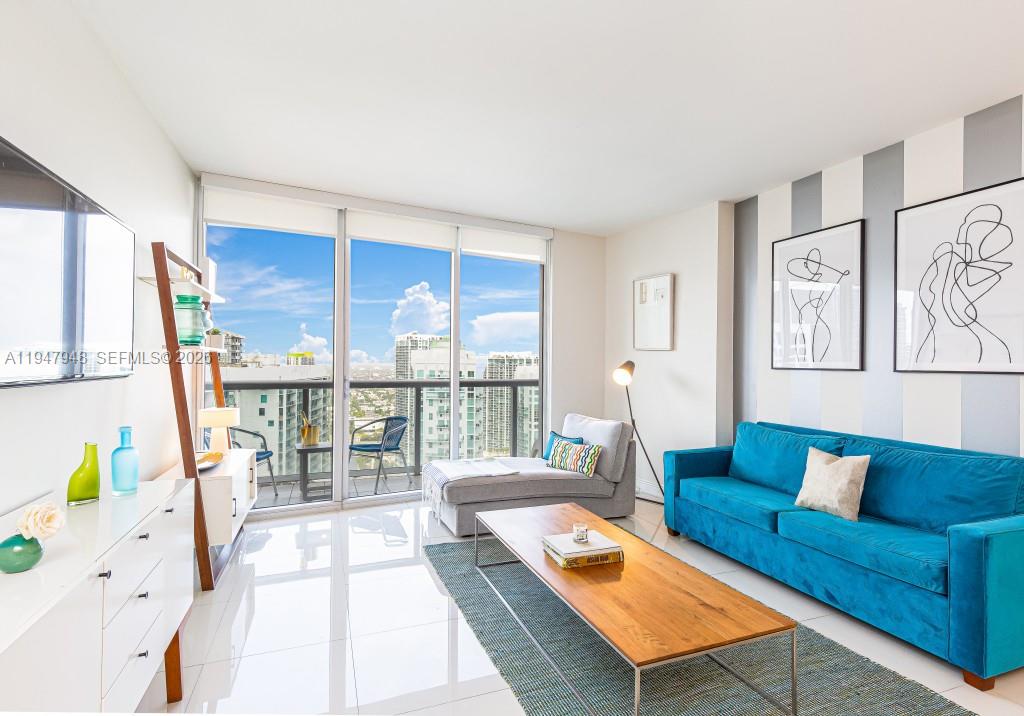 485 Brickell Avenue, Unit 4307 Miami, FL 33131 - Photo 3 of 21 a living room with furniture and a large window