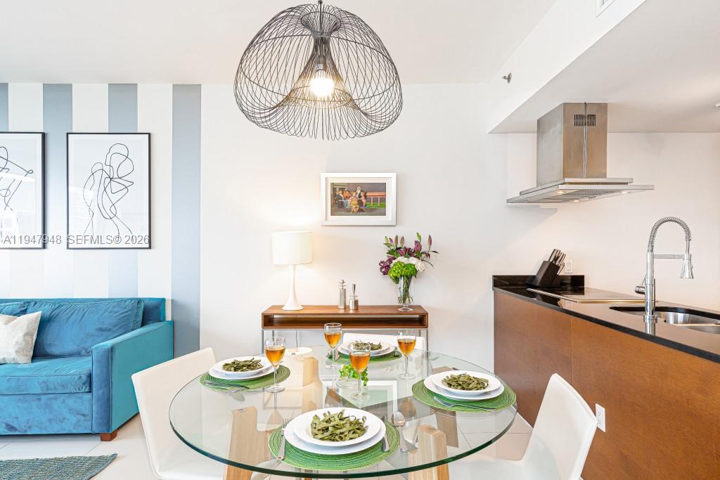 485 Brickell Avenue, Unit 4307 Miami, FL 33131 - Photo 5 of 21 a dining room with furniture and wooden floor