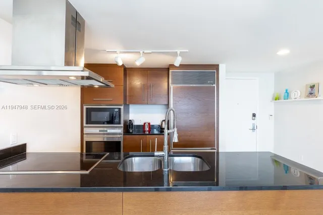 a kitchen with kitchen island a counter top space and cabinets