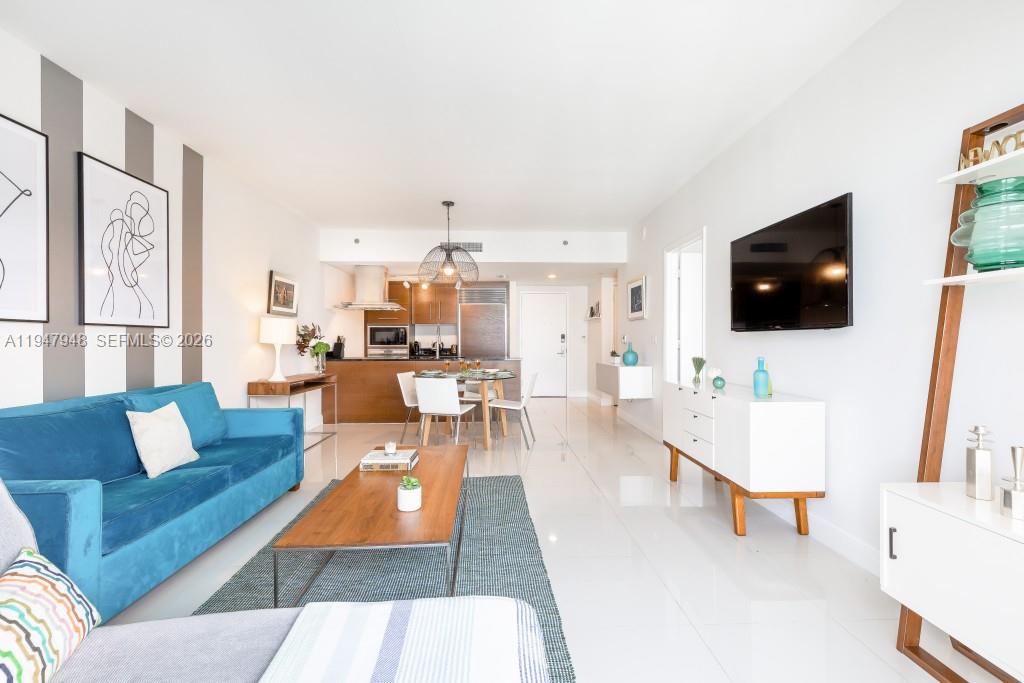 485 Brickell Avenue, Unit 4307 Miami, FL 33131 - Photo 8 of 21 a living room with furniture and a flat screen tv