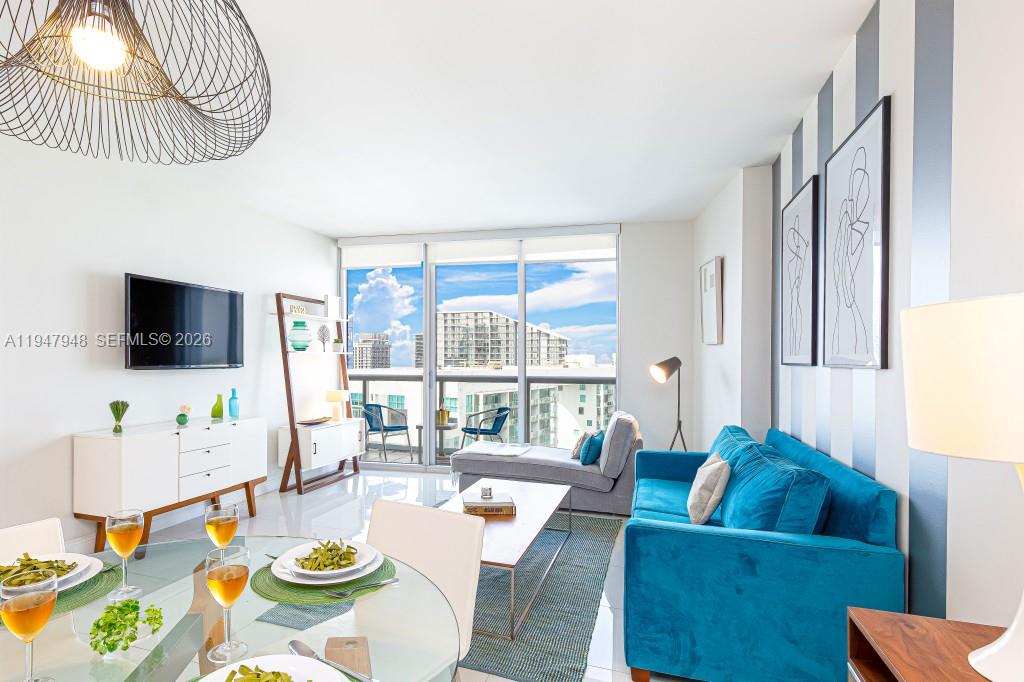 485 Brickell Avenue, Unit 4307 Miami, FL 33131 - Photo 10 of 21 a living room with furniture and a flat screen tv