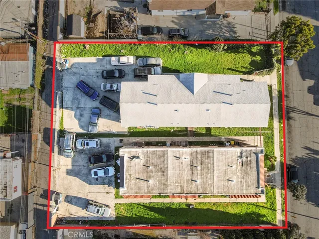 an aerial view of a building with garden space and outdoor seating