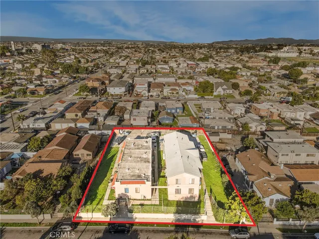 an aerial view of residential houses with outdoor space