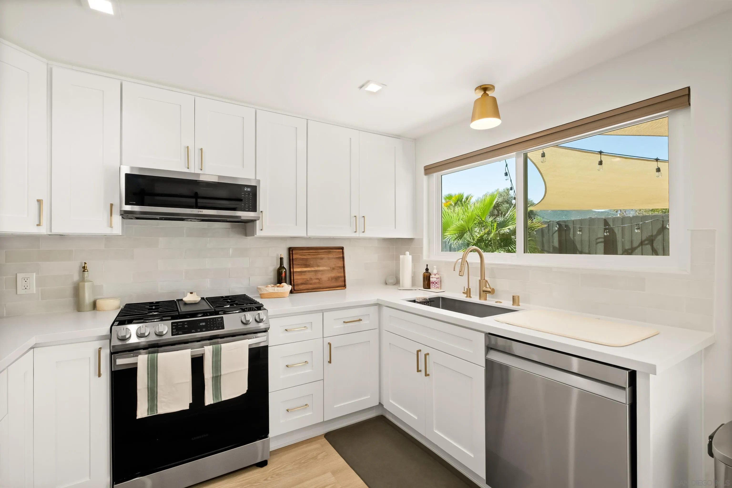 9081 Inverness Road Santee, CA 92071 - Photo 15 of 53 a kitchen with a sink stove and microwave