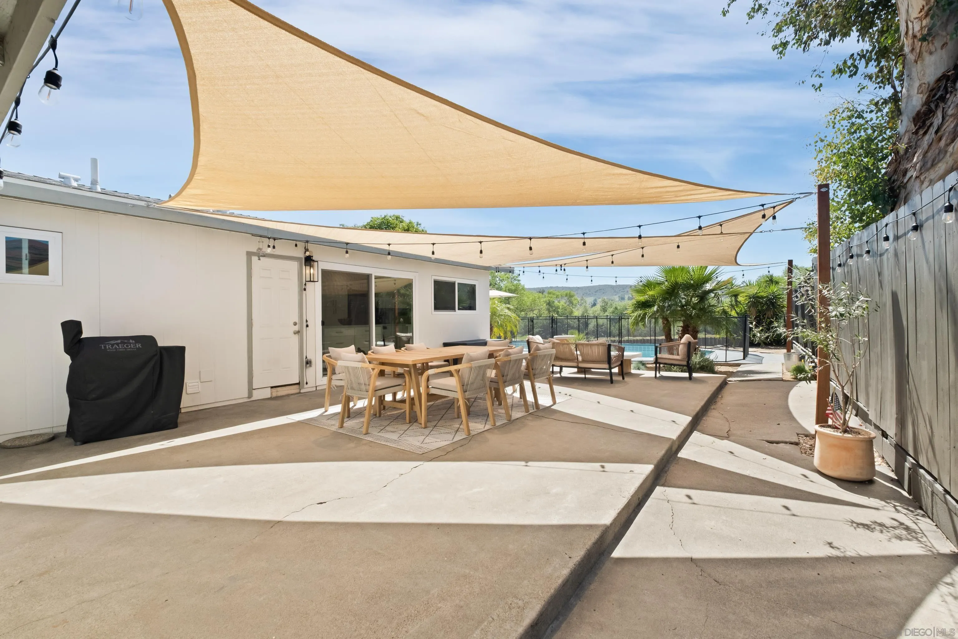 9081 Inverness Road Santee, CA 92071 - Photo 32 of 53 a view of a patio with a table and chairs under an umbrella