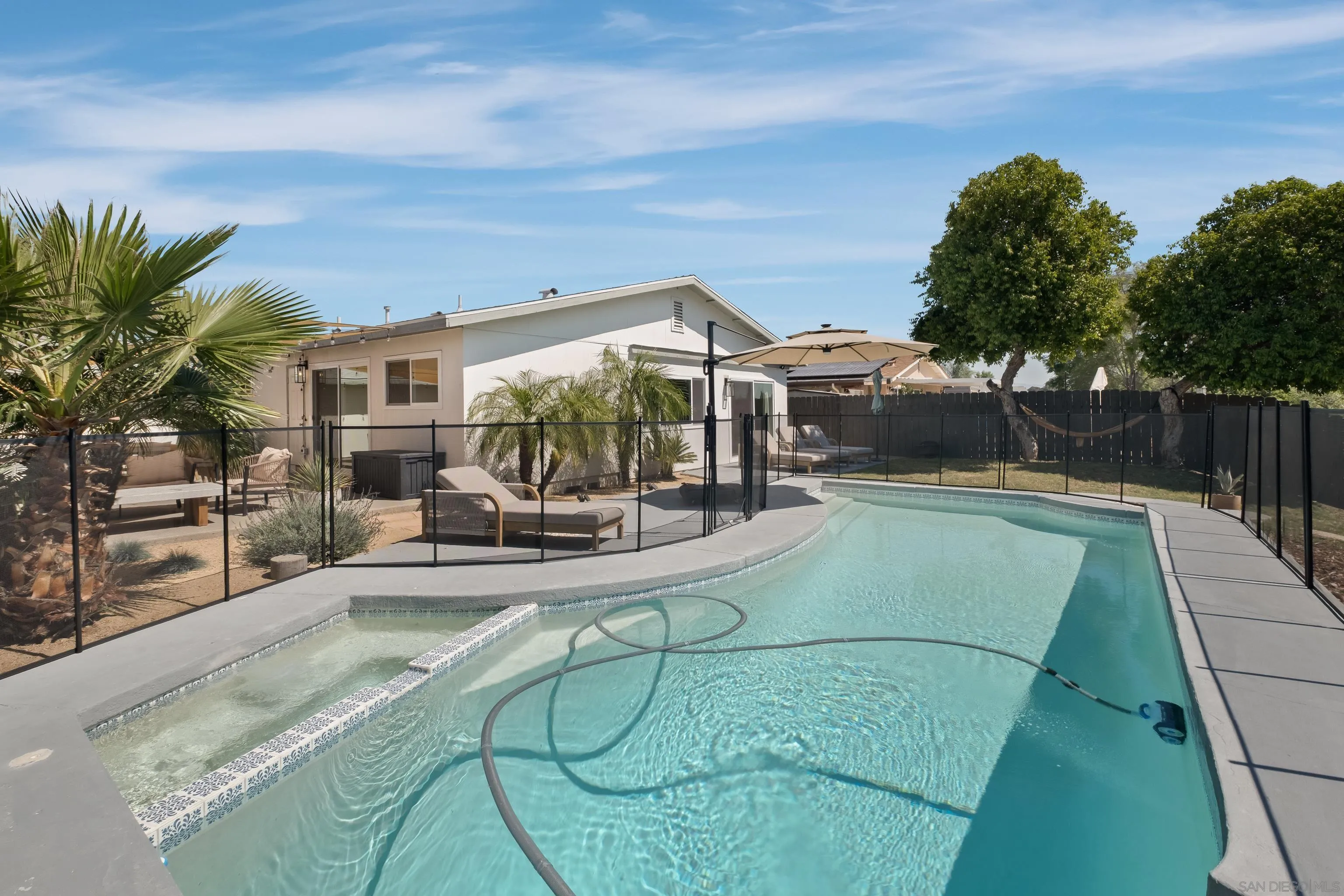 9081 Inverness Road Santee, CA 92071 - Photo 42 of 53 a view of a swimming pool with a patio and a yard