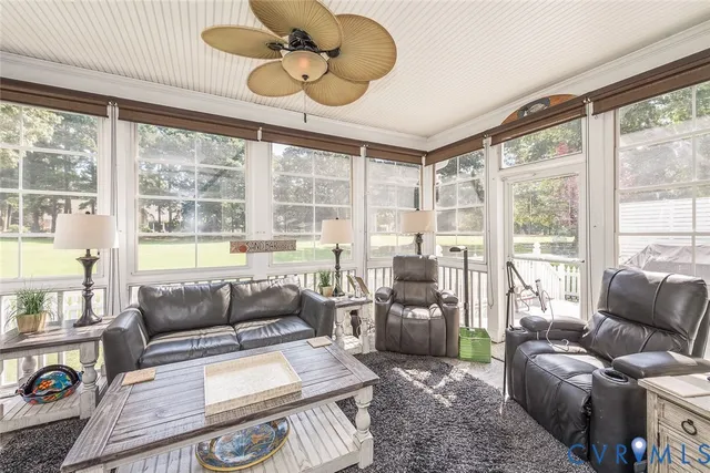 a living room with furniture and large windows
