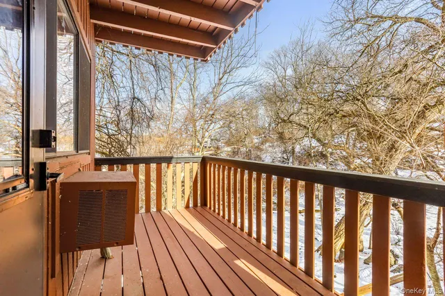 a view of a house with a small window and wooden fence