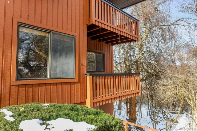 a view of balcony with wooden floor and outdoor seating