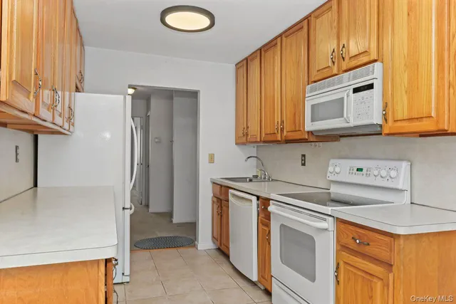 a kitchen with a sink stove and refrigerator