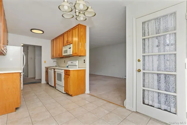 a view of a kitchen with microwave and cabinets