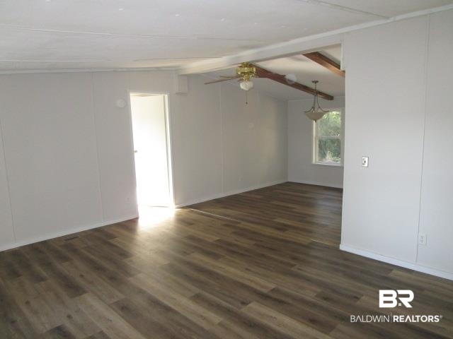 14791 Raber Road Summerdale, AL 36580 - Photo 6 of 21 Spare room featuring vaulted ceiling with beams, ceiling fan, and dark hardwood / wood-style flooring