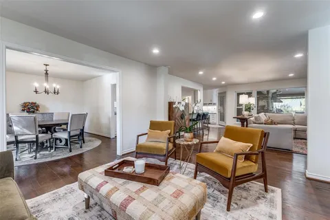 a living room with furniture a wooden floor and a table