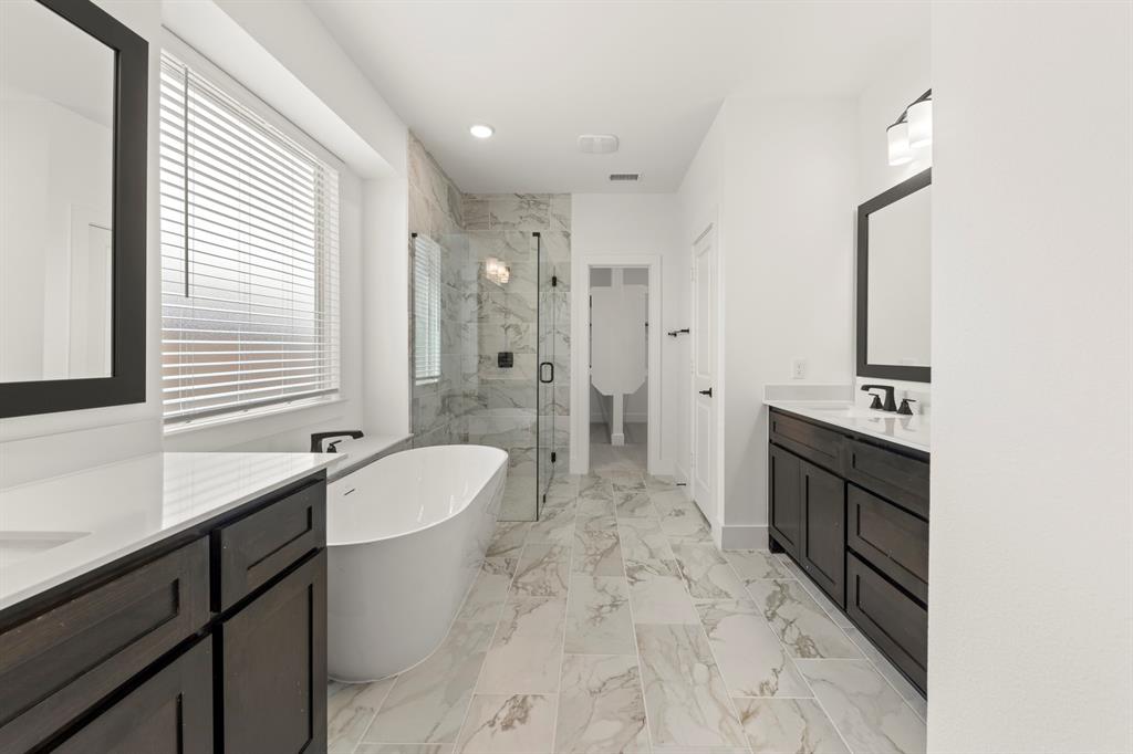 1335 Eclipse Way Wylie, TX 75098 - Photo 21 of 34 a spacious bathroom with a double vanity sink a mirror a bathtub and shower