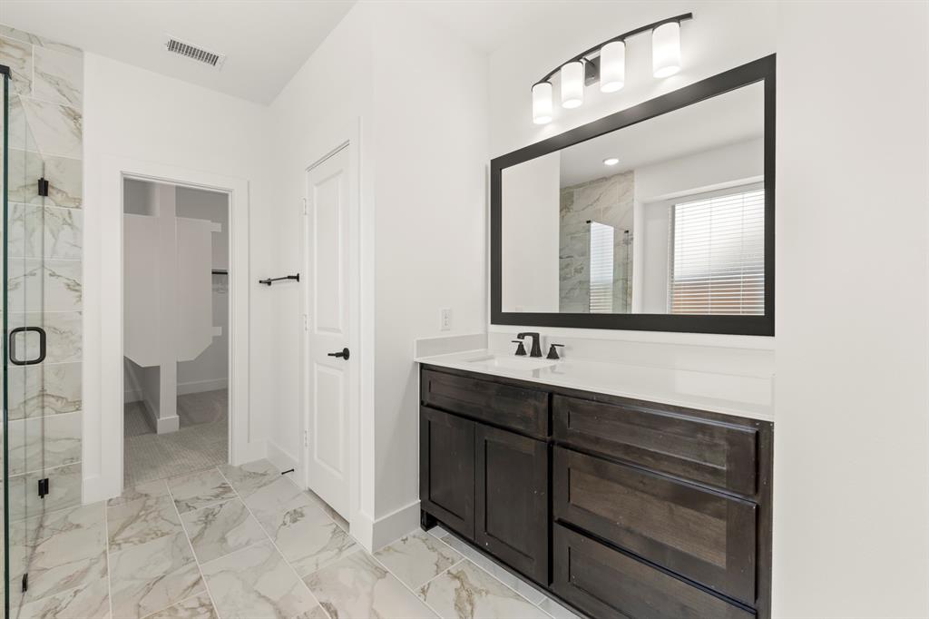 1335 Eclipse Way Wylie, TX 75098 - Photo 22 of 34 a bathroom with a toilet sink and mirror