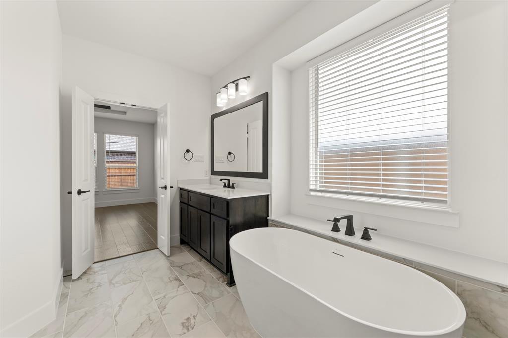 1335 Eclipse Way Wylie, TX 75098 - Photo 23 of 34 a spacious bathroom with a tub sink and mirror