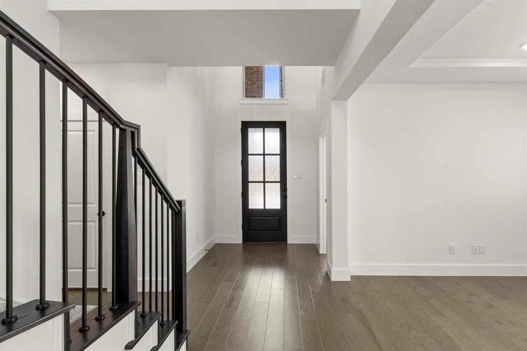 1335 Eclipse Way Wylie, TX 75098 - Photo 3 of 34 a view of a hallway with wooden floor and staircase