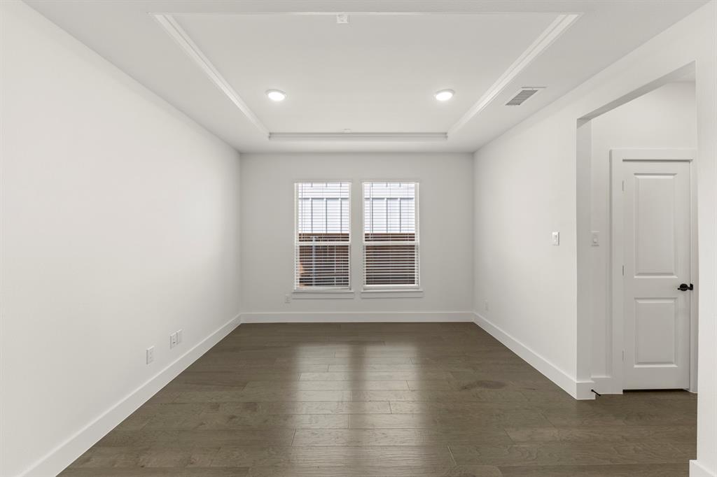 1335 Eclipse Way Wylie, TX 75098 - Photo 5 of 34 an empty room with wooden floor and windows