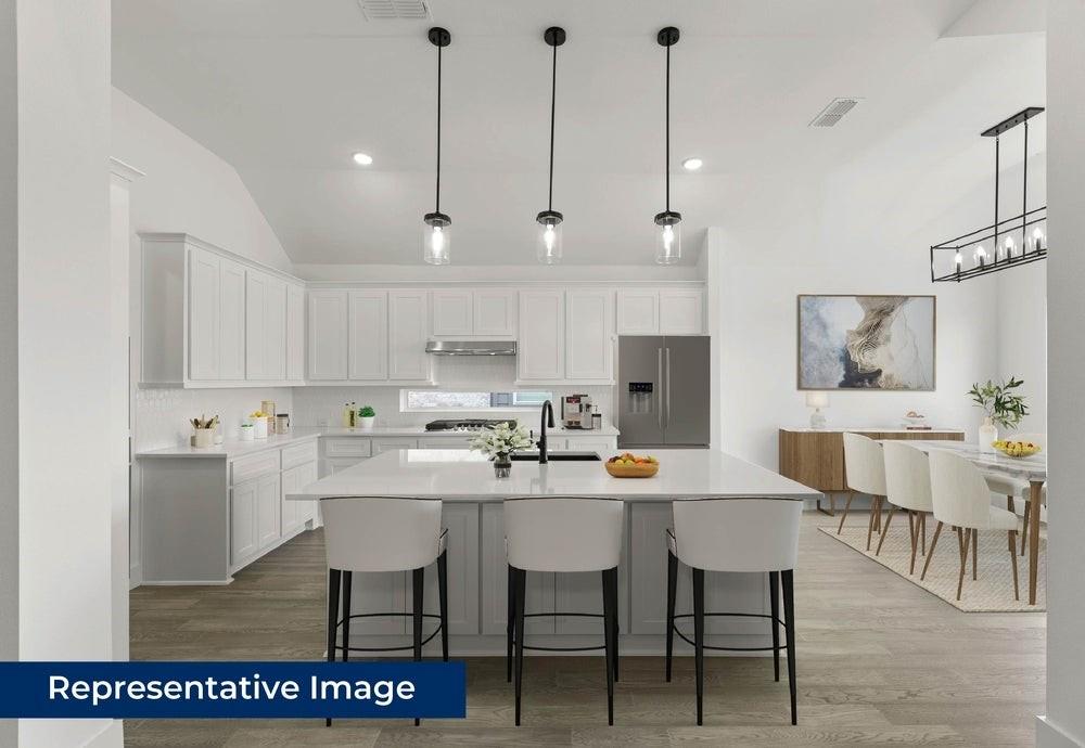 1335 Eclipse Way Wylie, TX 75098 - Photo 10 of 34 a kitchen with a dining table chairs and white cabinets