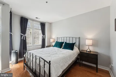 a bedroom with a bed and a lamp