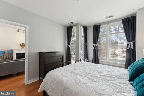 a bedroom with a bed dresser and a window