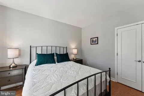 a bedroom with a bed and a night stand