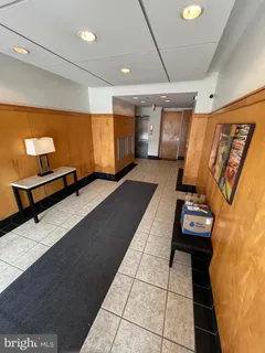 a hallway with a view of living room with furniture