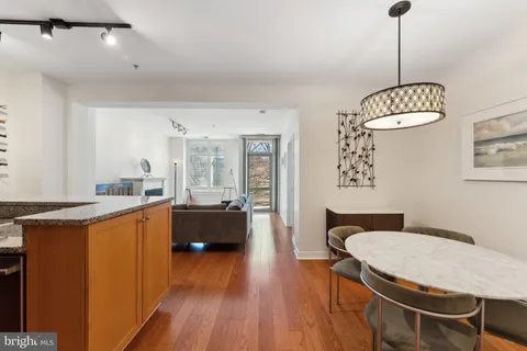 a kitchen with sink and wooden floor