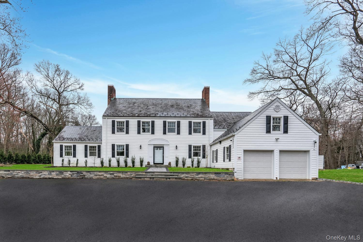 539 Split Rock Road Syosset, NY 11791 - Photo 2 of 40 Colonial inspired home with a garage, driveway, and a chimney