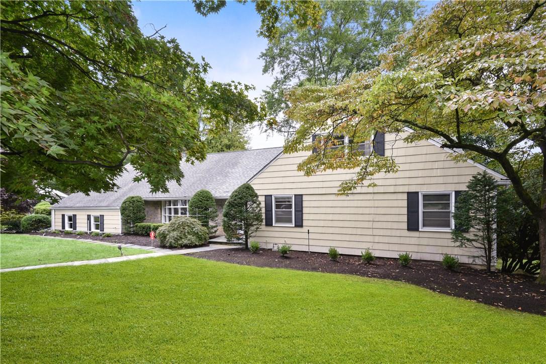 36 Aspen Road Scarsdale, NY 10583 - Photo 1 of 1 Front view of sprawling expanded ranch home.