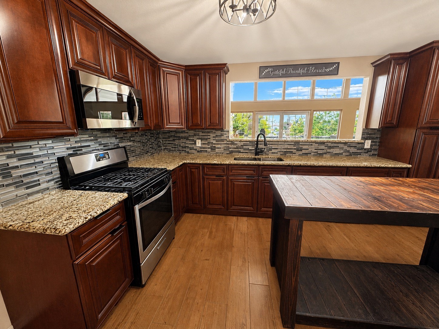 9012 Cooks Lake Road Lumberton, TX 77657 - Photo 6 of 36 a kitchen with a stove sink and cabinets