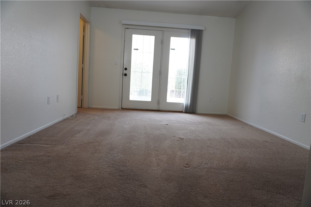 8328 Del Rey Avenue Las Vegas, NV 89117 - Photo 25 of 38 Patio access is easy from this room with durable carpet and a neutral color palette.