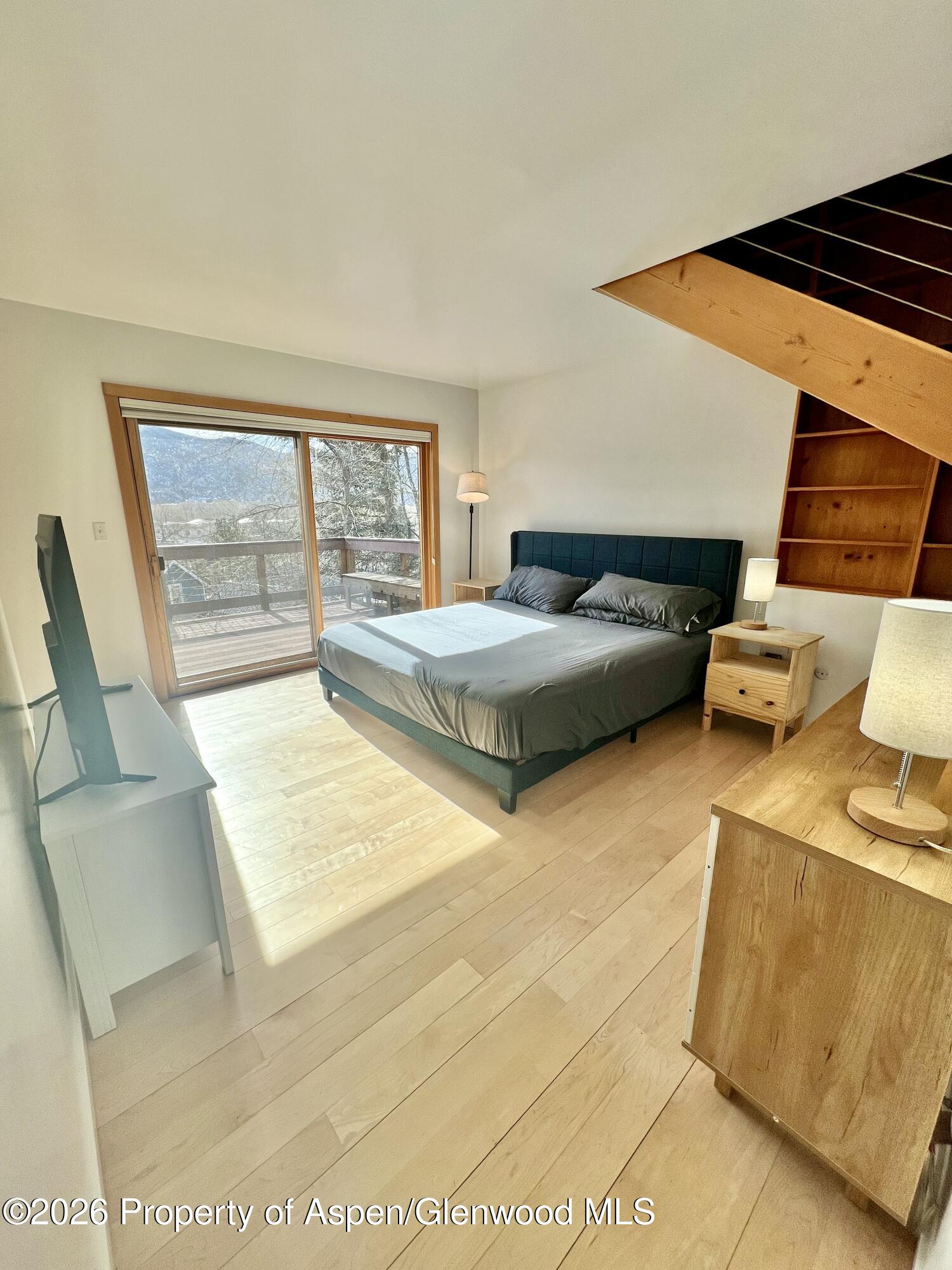 216 East Homestead Drive Basalt, CO 81621 - Photo 21 of 26 a bedroom with a bed and wooden floor