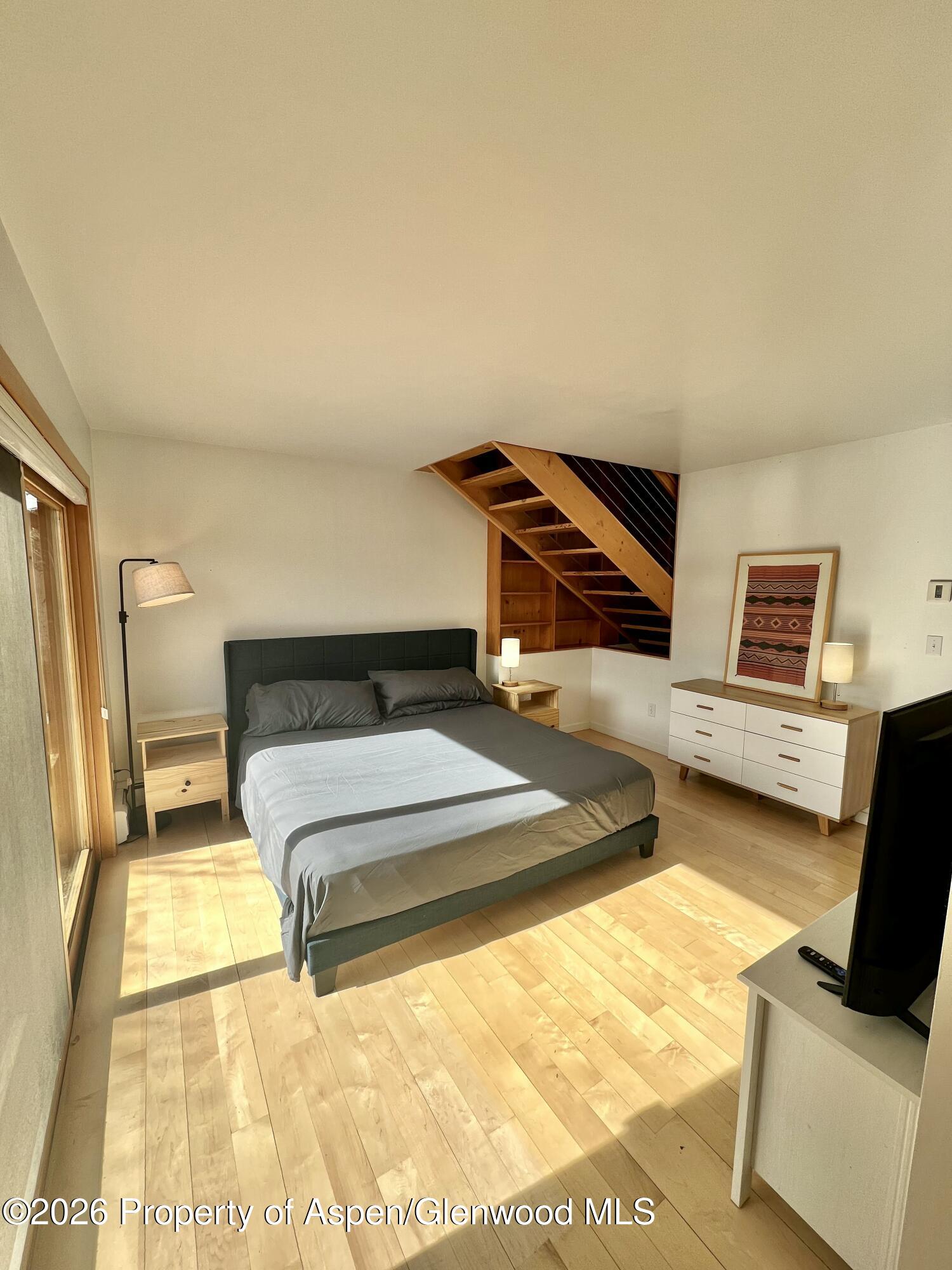 216 East Homestead Drive Basalt, CO 81621 - Photo 23 of 26 a bedroom with a bed and wooden floor