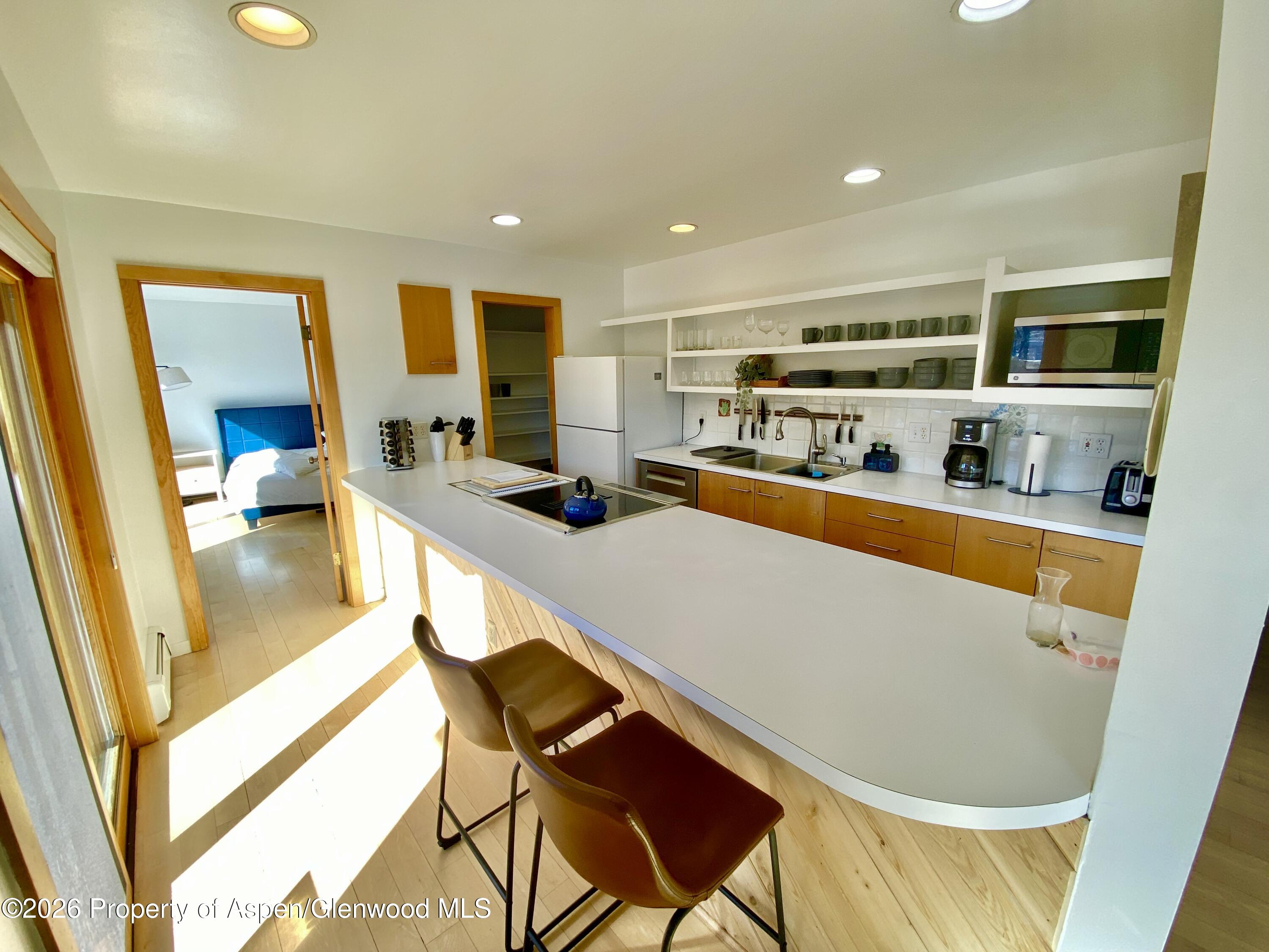 216 East Homestead Drive Basalt, CO 81621 - Photo 24 of 26 a dining room with stainless steel appliances furniture large window and wooden floor