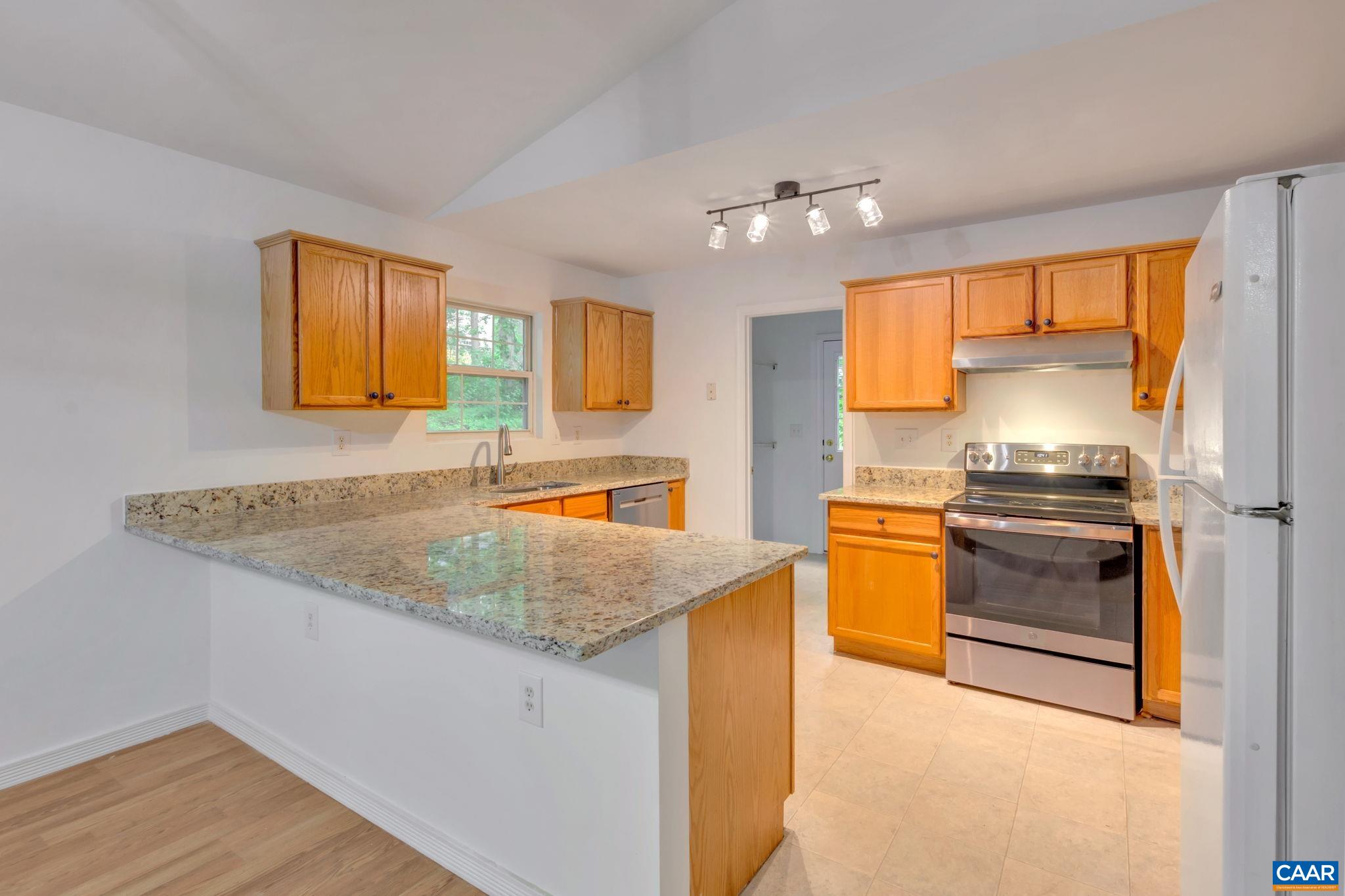 14 Hatchechubee Road Palmyra, VA 22963 - Photo 9 of 30 a kitchen with granite countertop counter top space a sink stainless steel appliances and a window