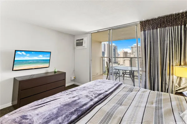 a bedroom with a bed and a flat screen tv