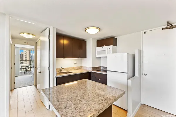a kitchen with a refrigerator and a stove top oven