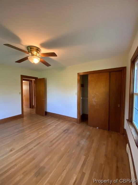 14 Light Street Heathsville, VA 22473 - Photo 11 of 18 Unfurnished bedroom with a closet, light wood-type flooring, ceiling fan, and a baseboard heating unit