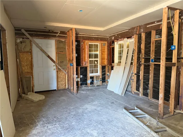 a view of a storage room with water heater and racks