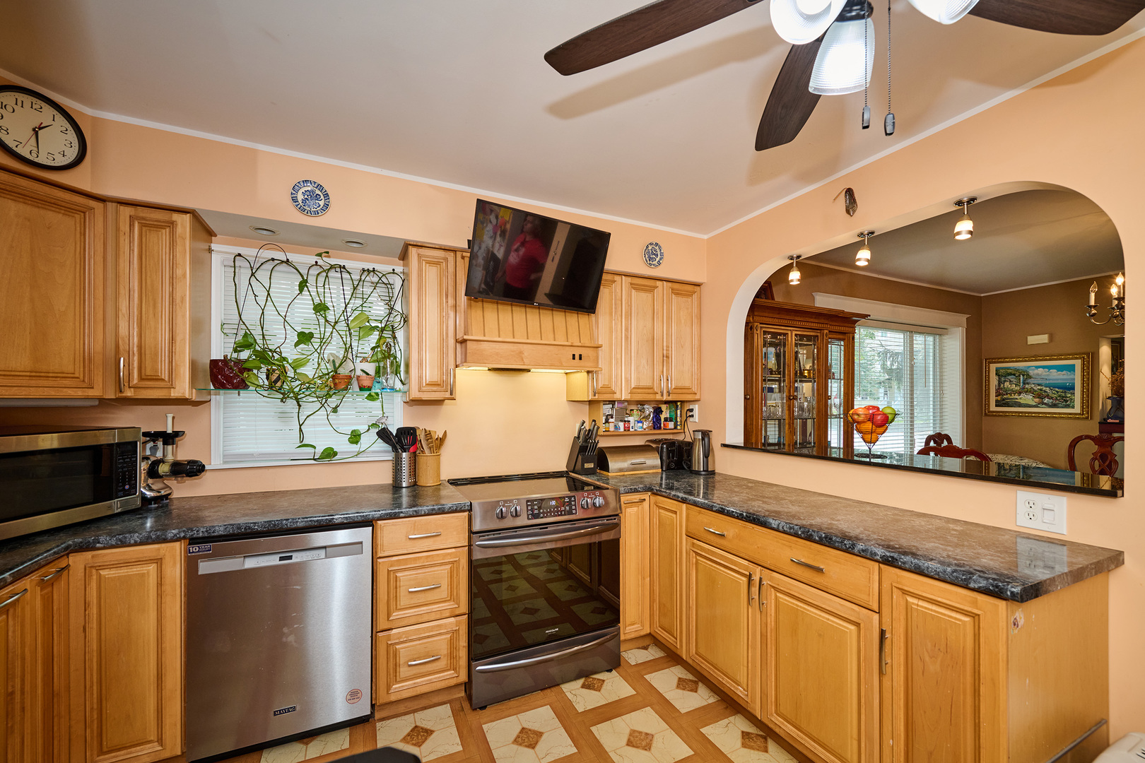 703 North Arlington Heights Road Arlington Heights, IL 60004 - Photo 12 of 28 a kitchen with stainless steel appliances granite countertop a sink and a stove