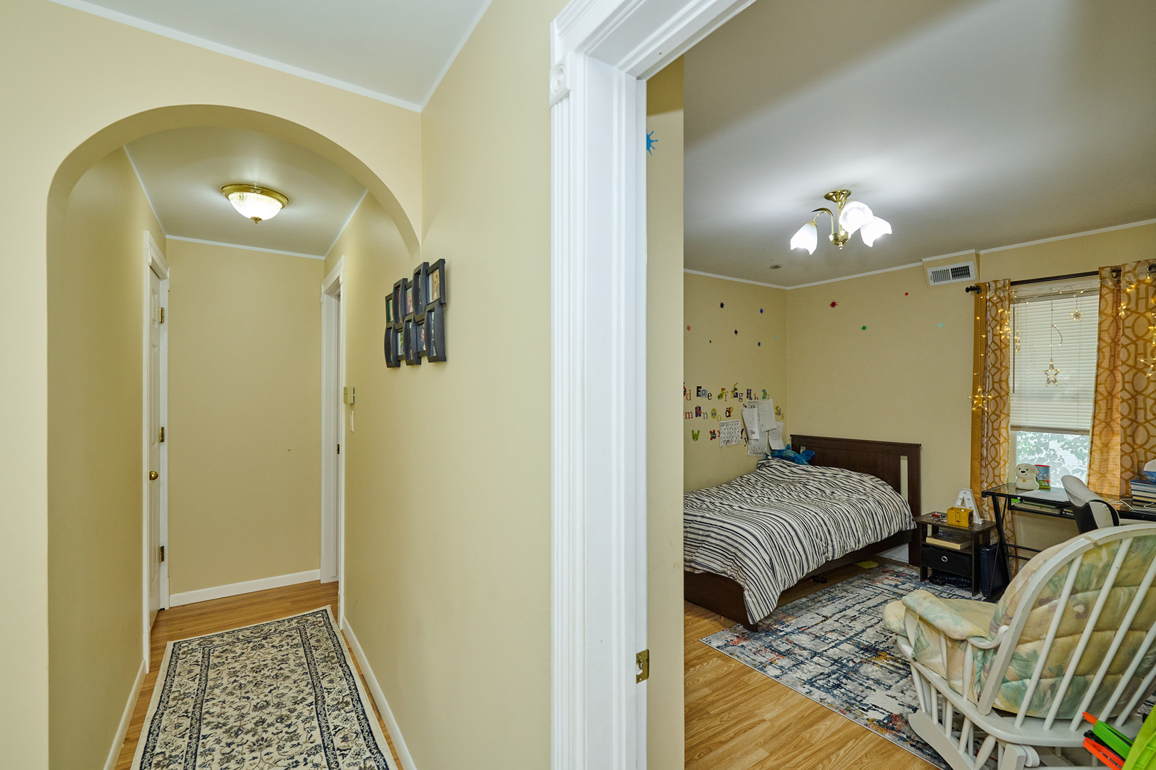 703 North Arlington Heights Road Arlington Heights, IL 60004 - Photo 20 of 28 a bedroom with a bed and a chandelier