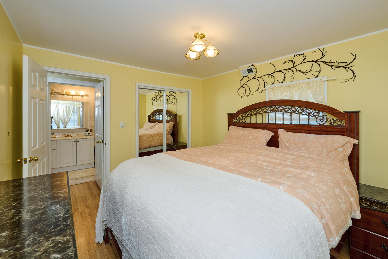 703 North Arlington Heights Road Arlington Heights, IL 60004 - Photo 22 of 28 a bedroom with a bed and a chandelier